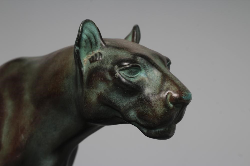 AN ART DECO BRONZED SPELTER LIONESS modelled standing with alert expression, green patination, Image