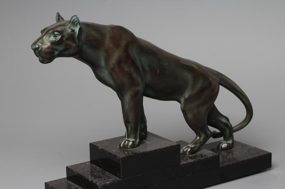AN ART DECO BRONZED SPELTER LIONESS modelled standing with alert expression, green patination, Image