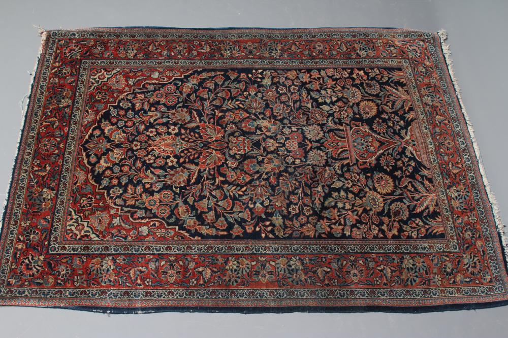 A PERSIAN RUG, 20th century, the navy blue mirhab with vase and flowers, red and ivory floral Image