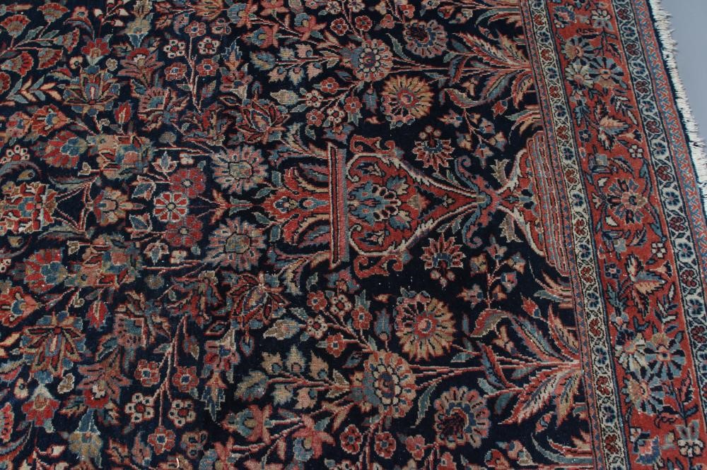 A PERSIAN RUG, 20th century, the navy blue mirhab with vase and flowers, red and ivory floral Image