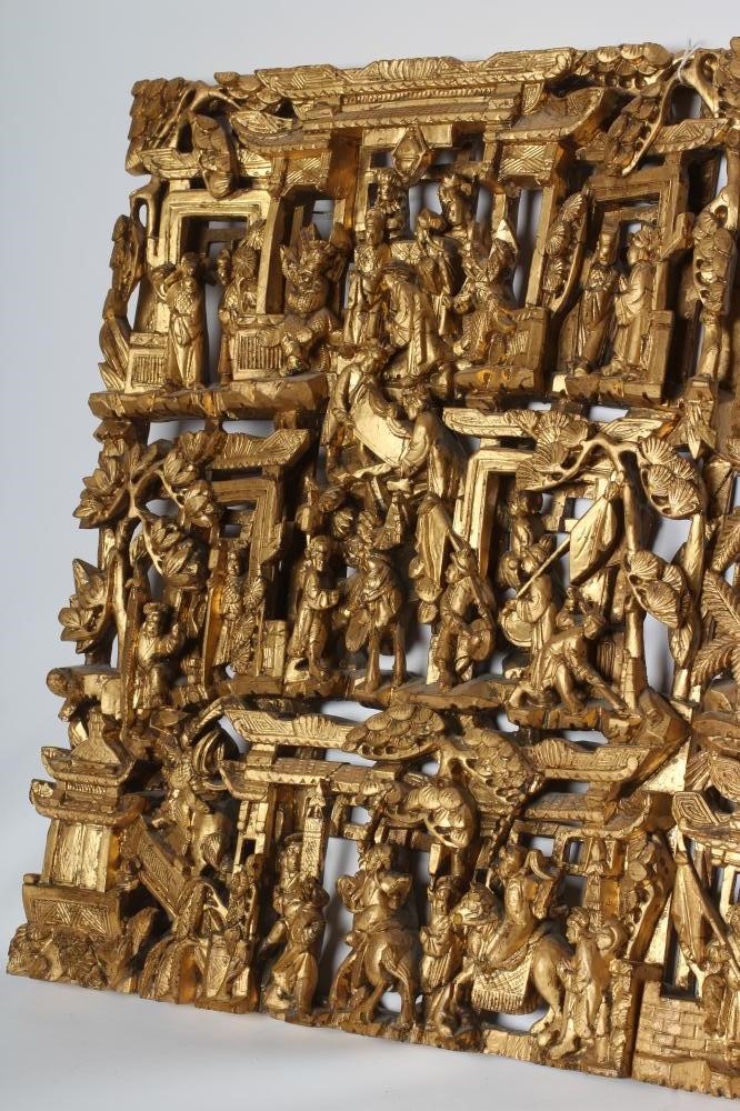 A PAIR OF CHINESE CARVED AND PIERCED GILTWOOD PANELS, c.1900, of oblong form with figures in a Image