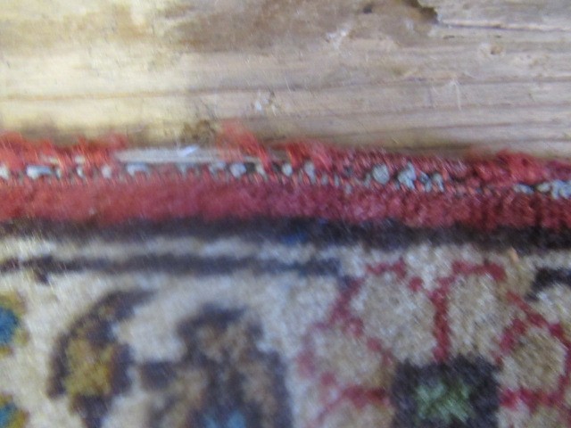 A PERSIAN RUG, early 20th century, the red floral field with central navy blue gul, navy blue main Image