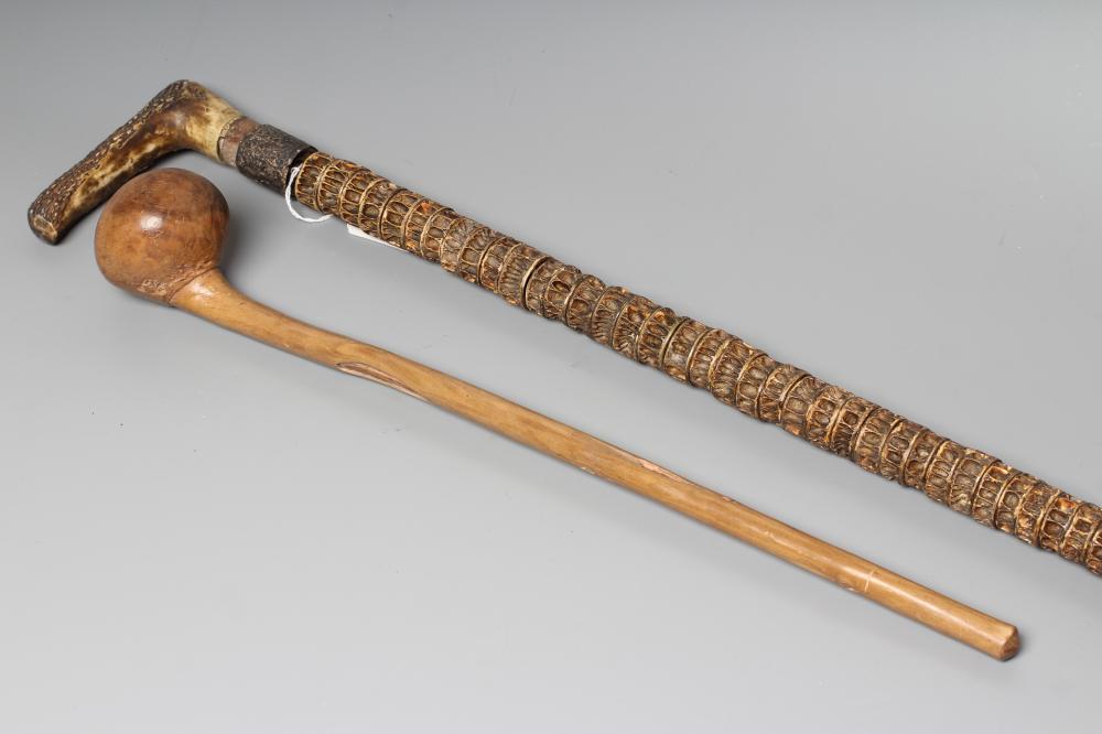 A VERTEBRAE WALKING STICK with antler grip, 35" long, together with an African knobkerrie, with root Image