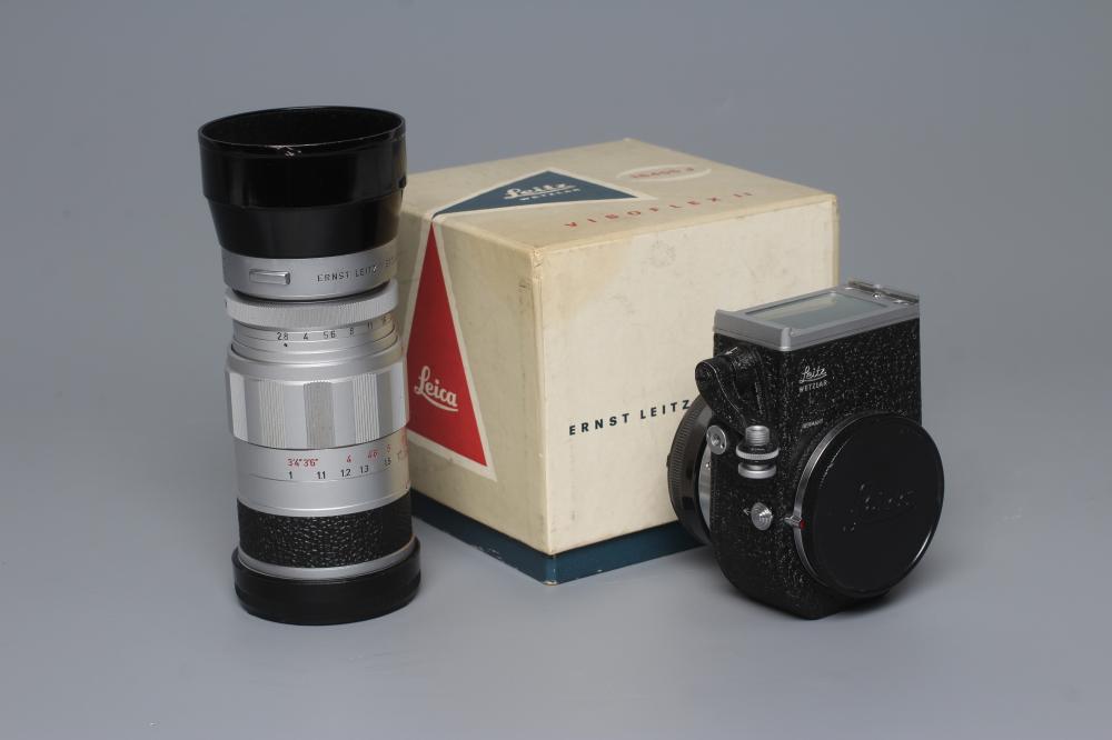 A LEITZ WETZLAR ELMARIT LENS, 1:2.8/90, 1692527, together with a Leitz Visoflex II (2) (Est. plus Image