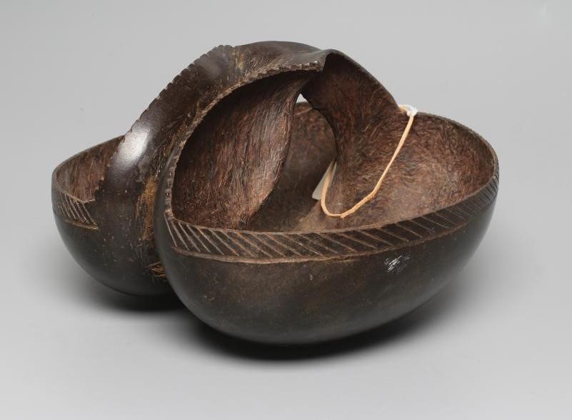 A COCO DE MER carved as a double-welled basket, with etched rim and polished exterior, 10 1/4" long Image