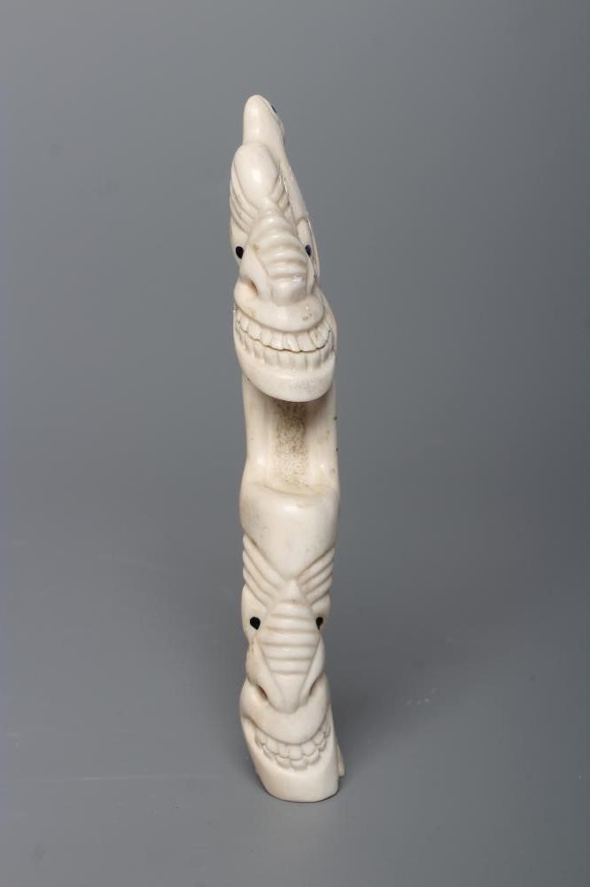 A CARVED INUIT TOTEM, made of polar bear bone, from Kulusuk-Kap Dam, Greenland, with three faces and Image