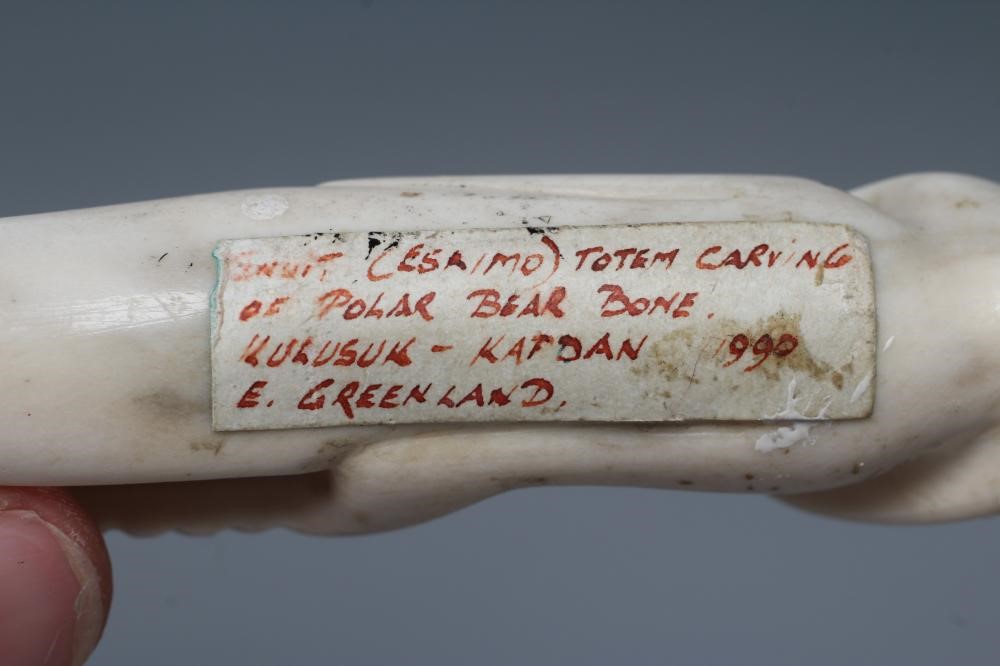 A CARVED INUIT TOTEM, made of polar bear bone, from Kulusuk-Kap Dam, Greenland, with three faces and Image