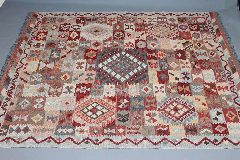A KILIM, modern, the pale blue ground in an overall geometric pattern small square in rust, brown Image