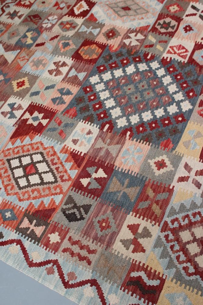 A KILIM, modern, the pale blue ground in an overall geometric pattern small square in rust, brown Image