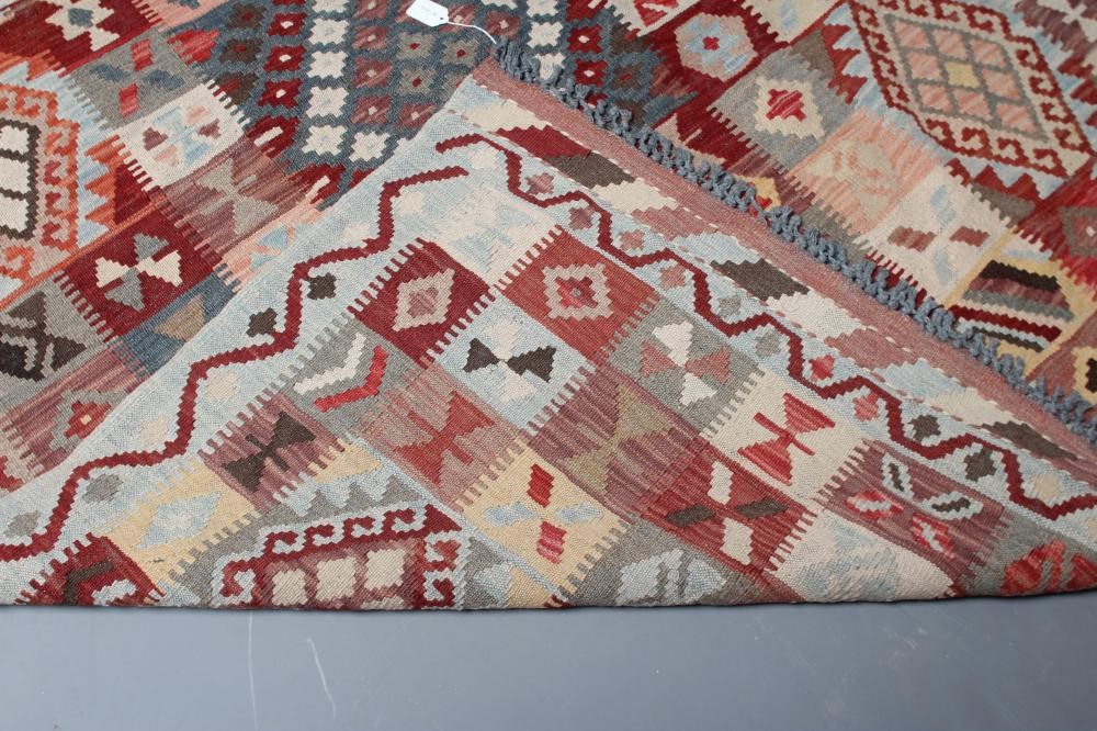 A KILIM, modern, the pale blue ground in an overall geometric pattern small square in rust, brown Image
