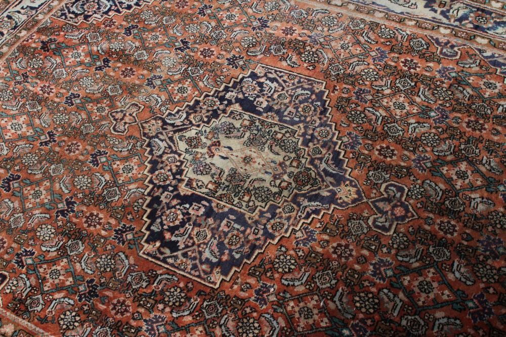 A PERSIAN RUG, 20th century, the red floral field with navy blue centre gul and spandrels, with navy Image
