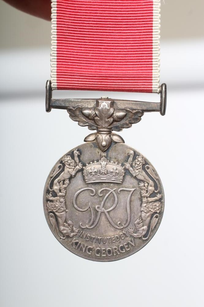 AN EMPIRE MEDAL with George V monogram and red ribbon with white edges, named "THOMAS LITTLE" (Est. Image