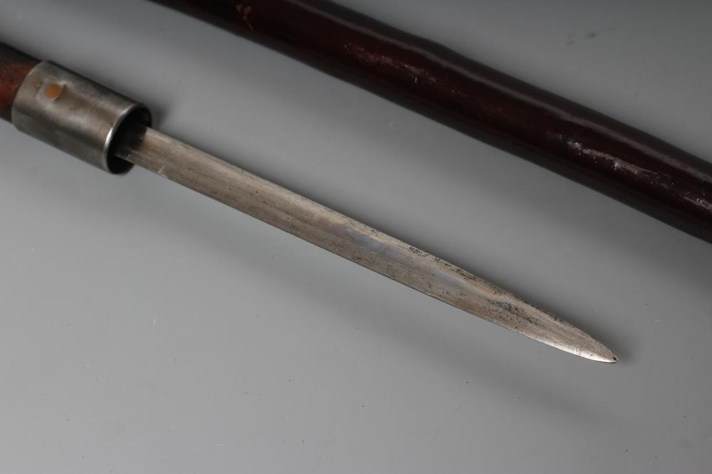 A SWORD STICK, early 20th century, with 5 1/2" double edged blade, metal ferrule and crooked handle, Image