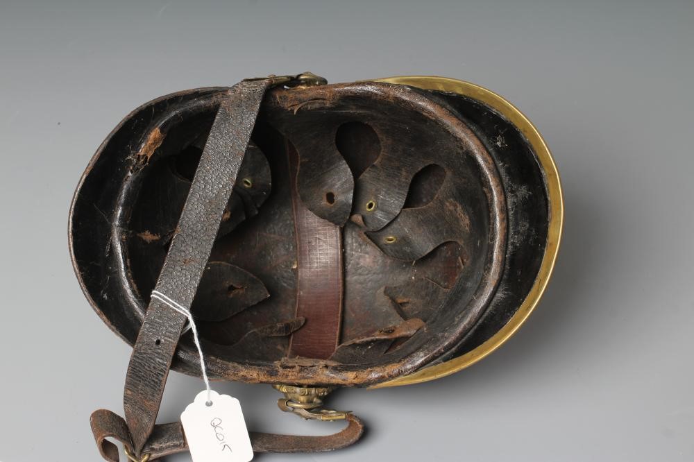 AN AUSTRIAN FIREMAN'S LEATHER HELMET with brass crest, badge, lion head bosses and leather chin Image