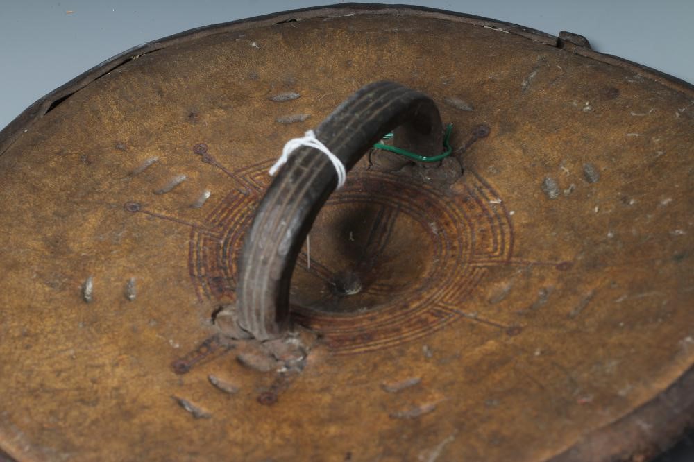 TWO AFRICAN HIDE SHIELDS, possibly Somalian, of circular form, with embossed geometric design and Image