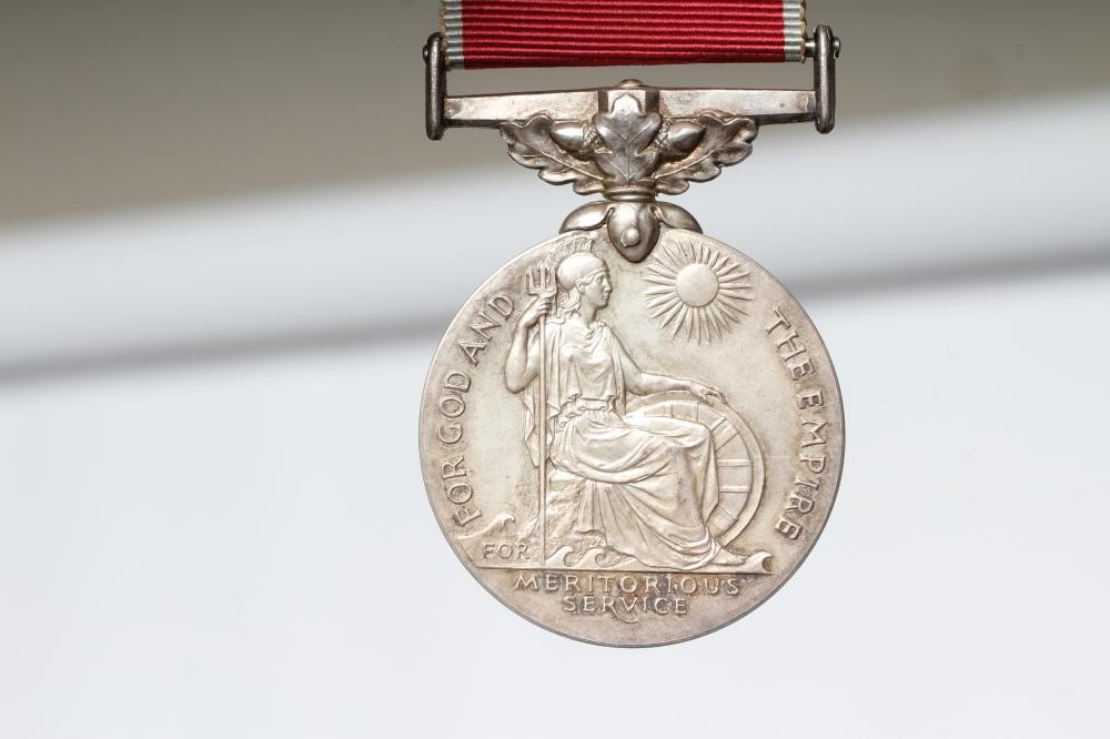 A BRITISH EMPIRE MEDAL awarded to Walter Pedley Bywater, with red and white ribbon, spare ribbon and Image