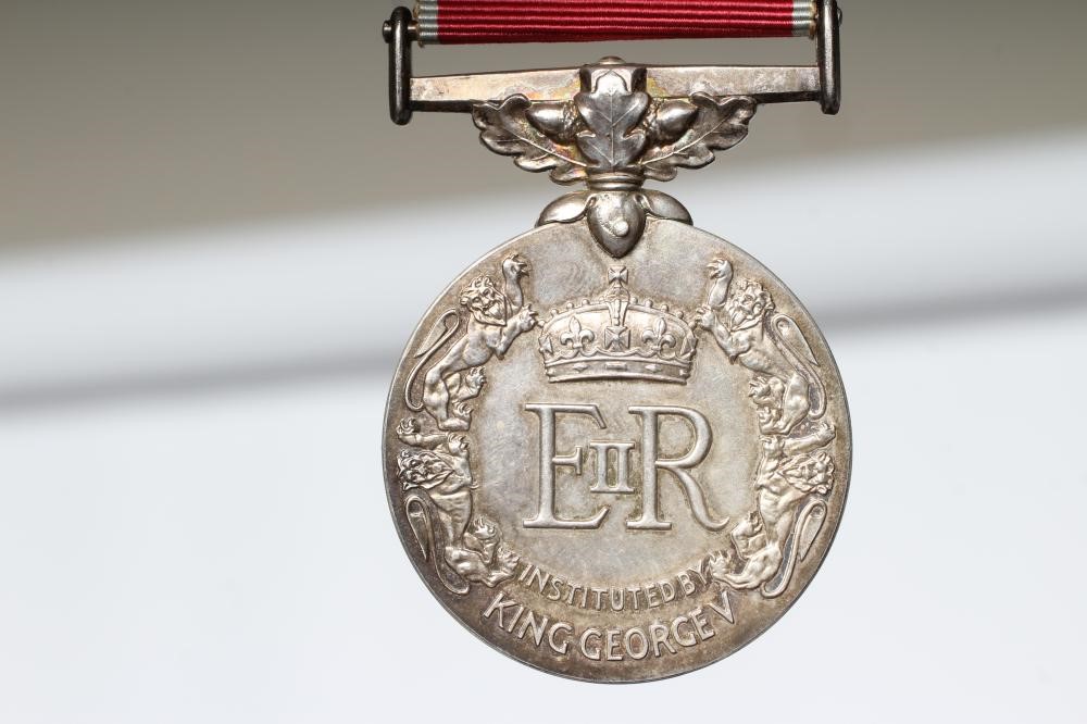 A BRITISH EMPIRE MEDAL awarded to Walter Pedley Bywater, with red and white ribbon, spare ribbon and Image