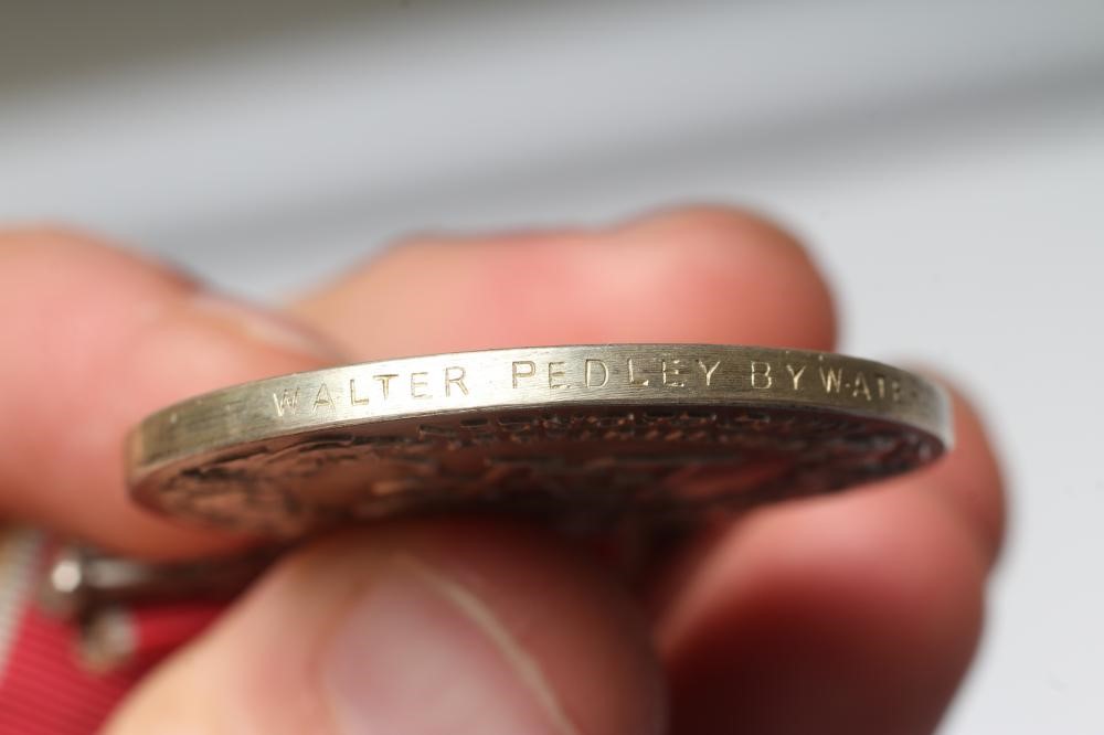 A BRITISH EMPIRE MEDAL awarded to Walter Pedley Bywater, with red and white ribbon, spare ribbon and Image