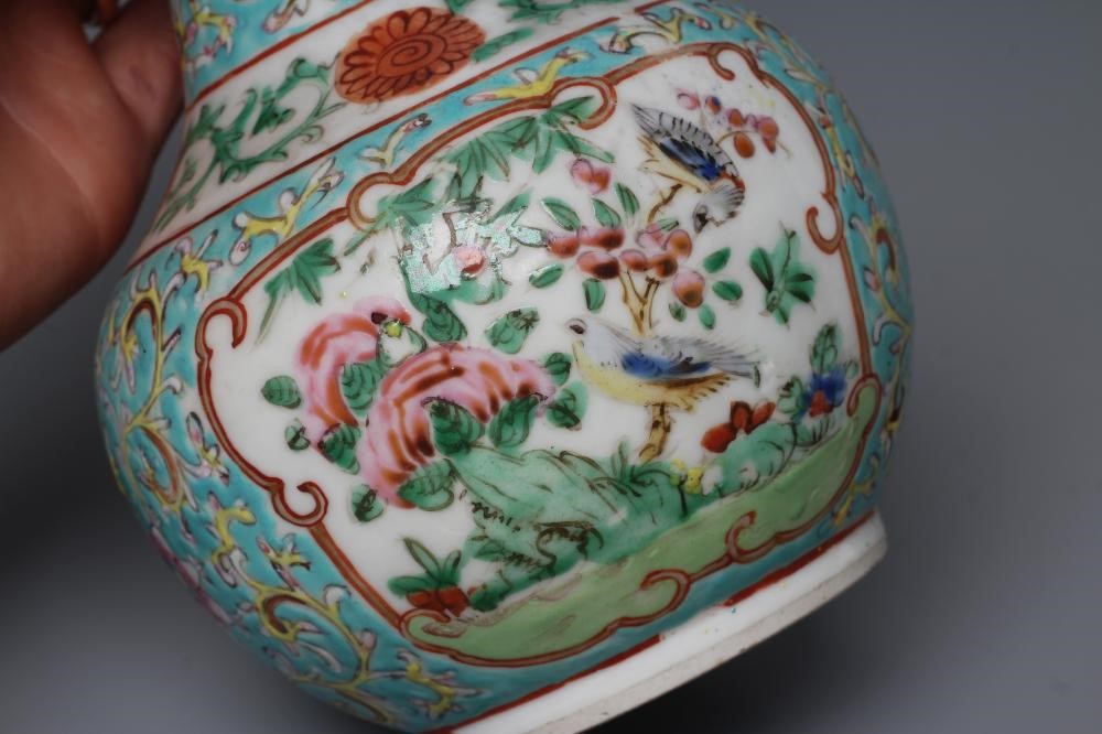 A CHINESE PORCELAIN BOTTLE VASE painted in colours with panels of flowers, birds and butterflies on Image