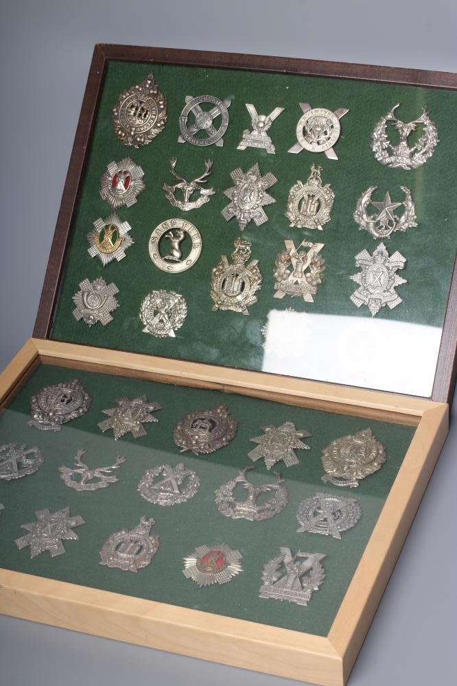THIRTY FOUR BRITISH MILITARY CAP BADGES comprising all Scottish regiments in two framed cases Image