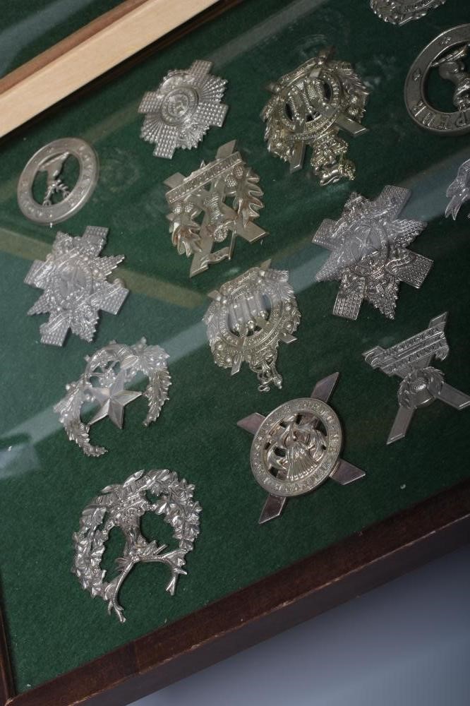 THIRTY FOUR BRITISH MILITARY CAP BADGES comprising all Scottish regiments in two framed cases Image