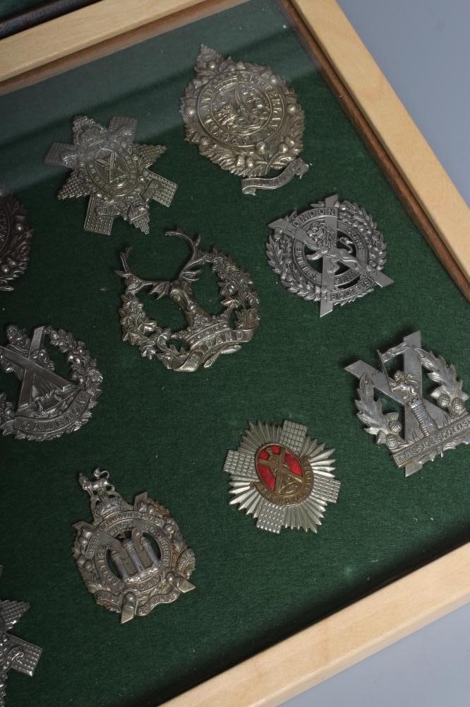 THIRTY FOUR BRITISH MILITARY CAP BADGES comprising all Scottish regiments in two framed cases Image