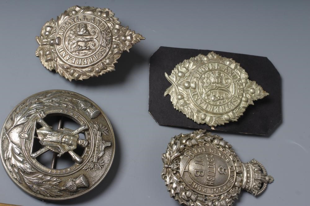 A COLLECTION OF BRITISH MILITARY CAP BADGES AND PLAID BROOCHES including a Victorian Royal Irish Image