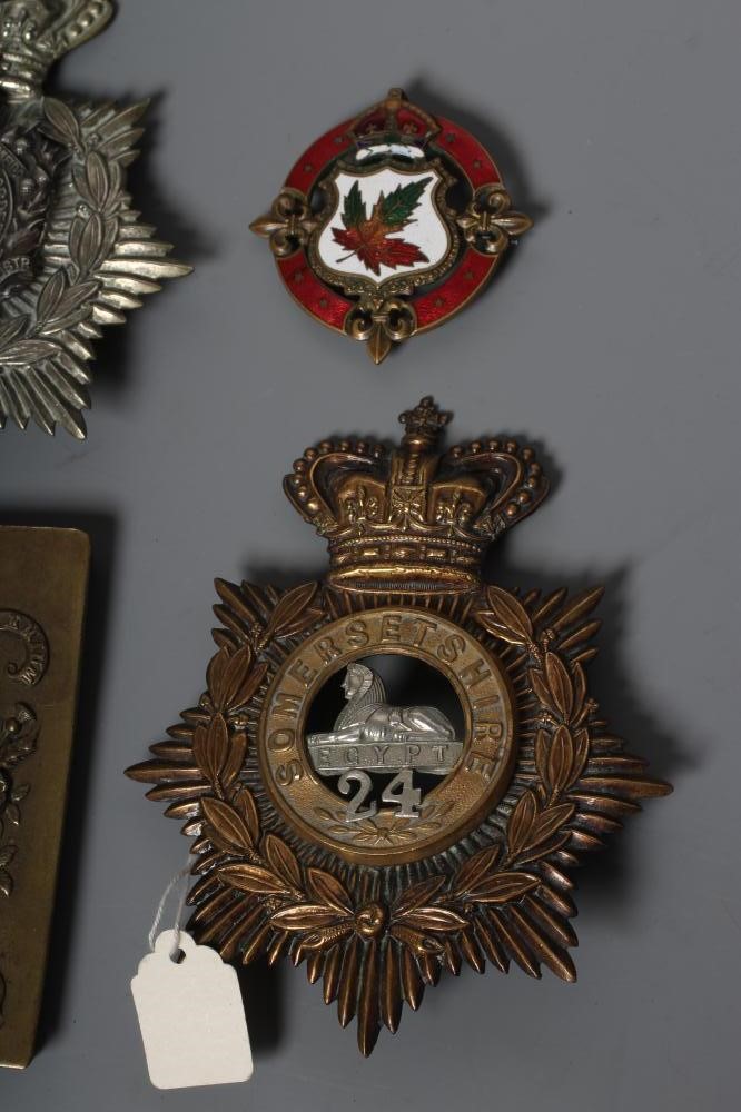 A COLLECTION OF BRITISH MILITARY CAP BADGES AND PLAID BROOCHES including a Victorian Royal Irish Image