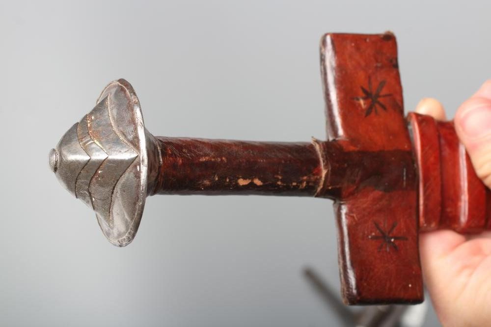 TWO AFRICAN HAUSA SWORDS comprising one of typical form with steel crossguard and leather grip, and Image