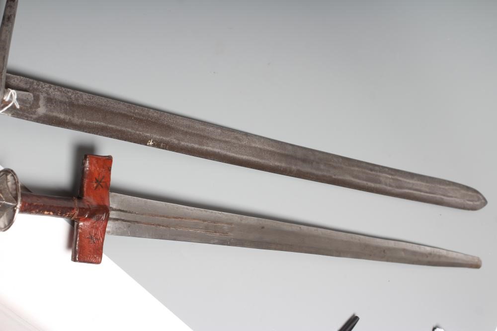 TWO AFRICAN HAUSA SWORDS comprising one of typical form with steel crossguard and leather grip, and Image
