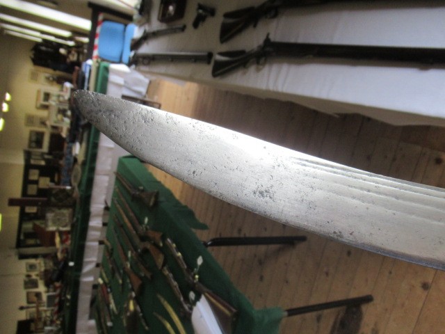 AN INDIAN TALWAR, possibly early 19th century, with 29 1/2" curved thick blade, brass and steel hilt Image