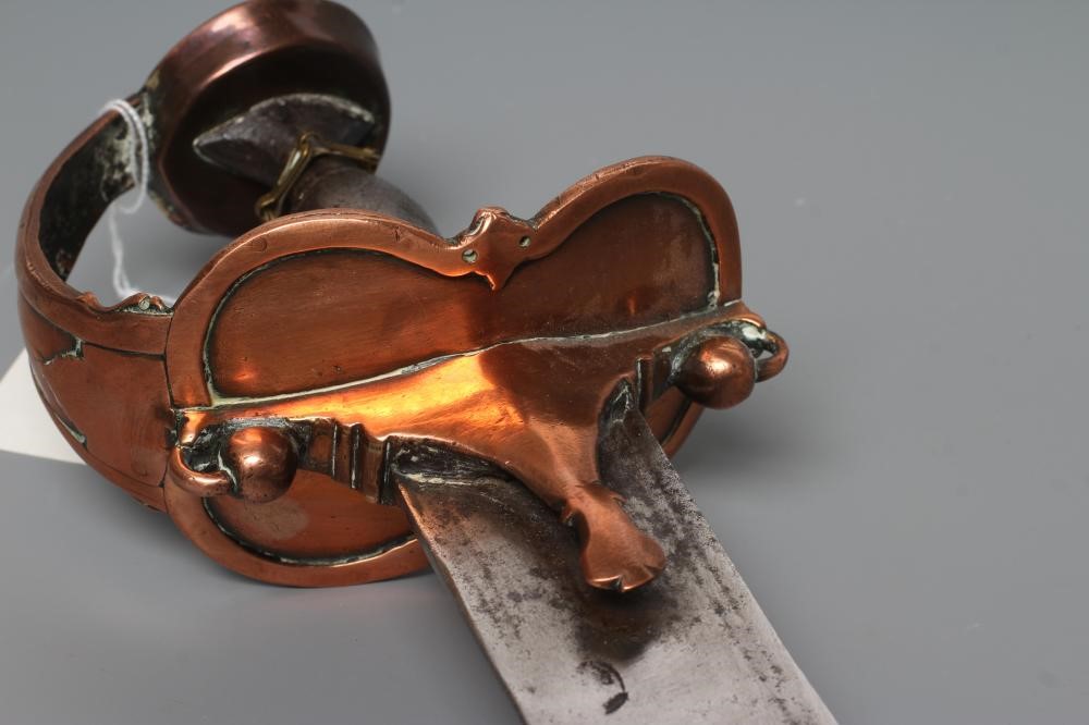 AN INDIAN TALWAR, possibly early 19th century, with 29 1/2" curved thick blade, brass and steel hilt Image