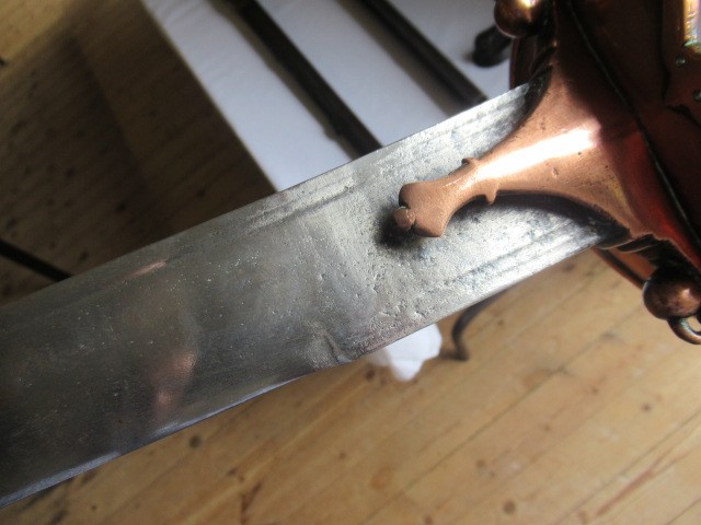 AN INDIAN TALWAR, possibly early 19th century, with 29 1/2" curved thick blade, brass and steel hilt Image