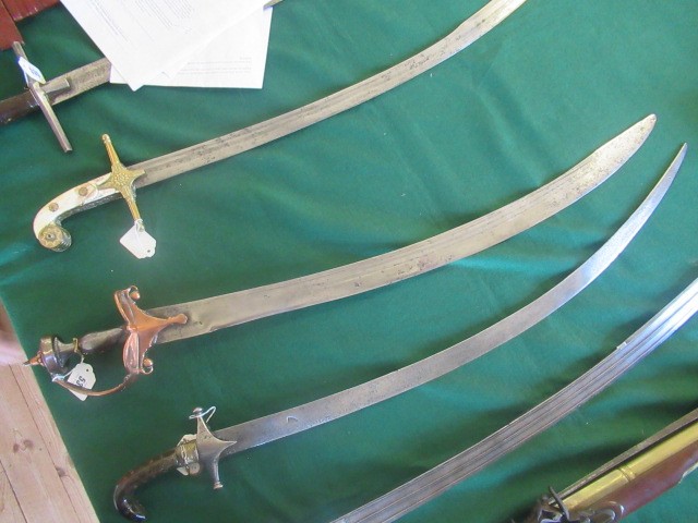 AN INDIAN TALWAR, possibly early 19th century, with 29 1/2" curved thick blade, brass and steel hilt Image