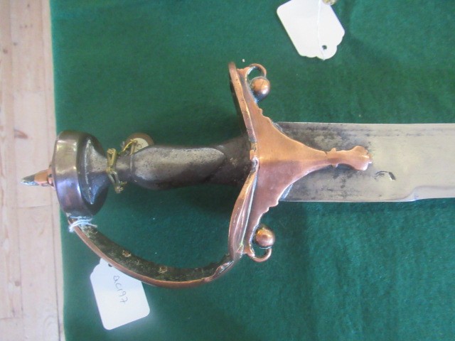 AN INDIAN TALWAR, possibly early 19th century, with 29 1/2" curved thick blade, brass and steel hilt Image