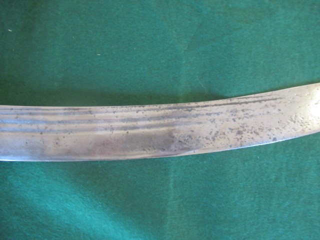 AN INDIAN TALWAR, possibly early 19th century, with 29 1/2" curved thick blade, brass and steel hilt Image