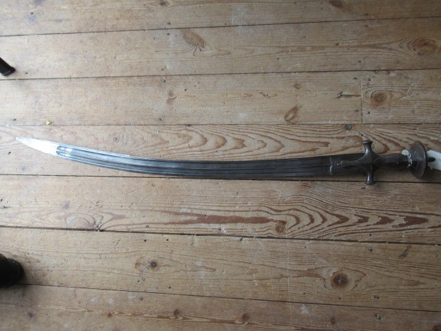 AN INDIAN TALWAR, 19th century, the 29 1/4" curved blade with fine fullers and edge shaping, and Image