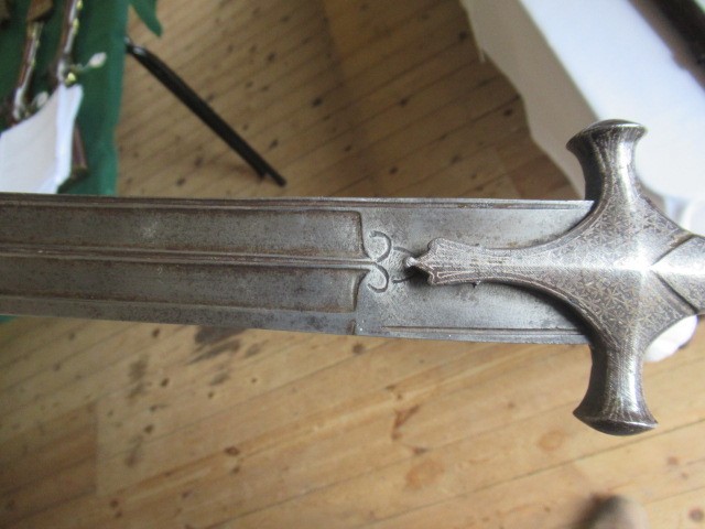 AN INDIAN TALWAR, 19th century, the 29 1/4" curved blade with fine fullers and edge shaping, and Image