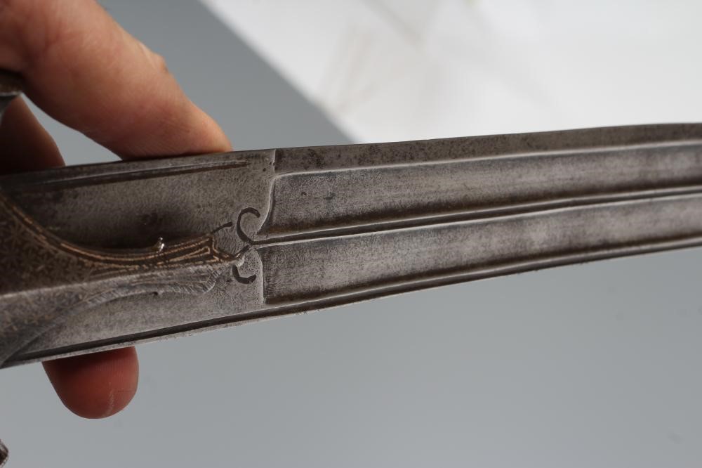 AN INDIAN TALWAR, 19th century, the 29 1/4" curved blade with fine fullers and edge shaping, and Image