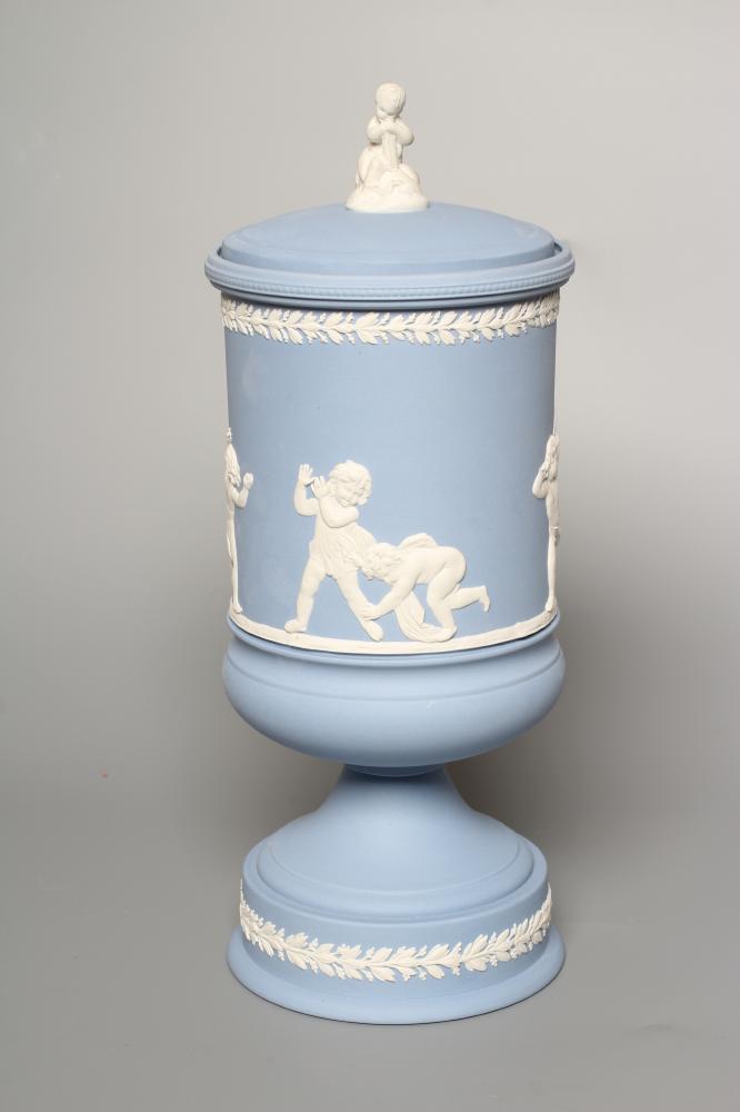 A WEDGWOOD BLUE JASPERWARE PEDESTAL VASE AND COVER, modern, of cylindrical form, moulded and applied Image