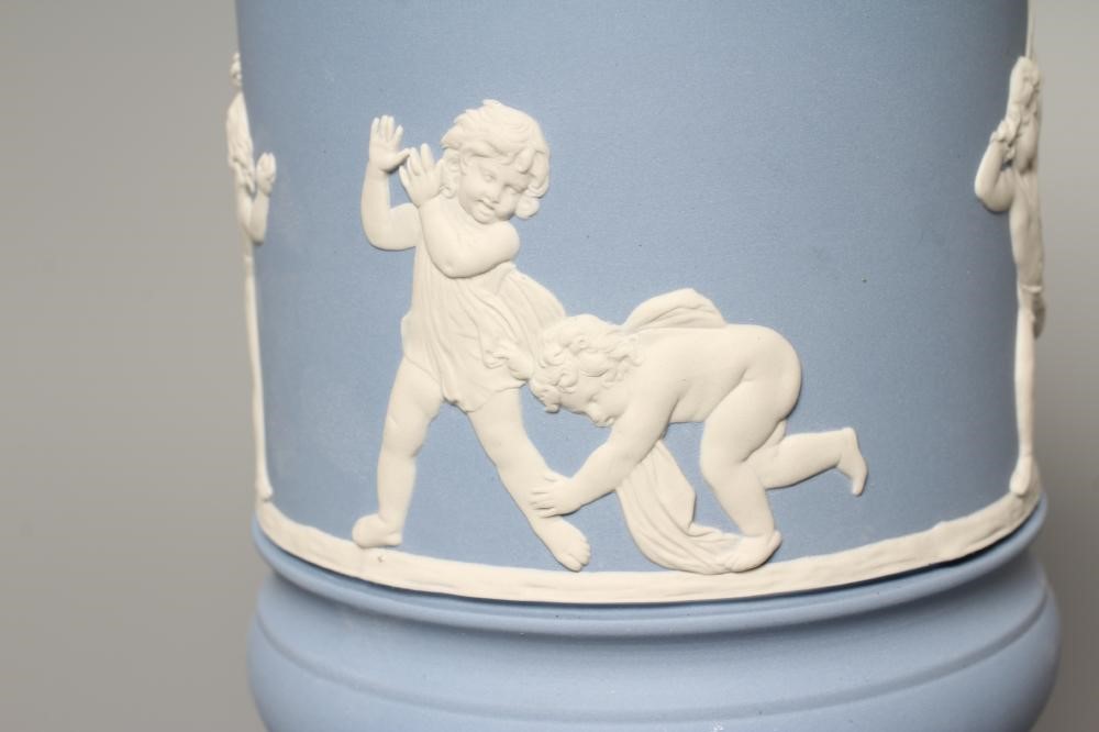 A WEDGWOOD BLUE JASPERWARE PEDESTAL VASE AND COVER, modern, of cylindrical form, moulded and applied Image