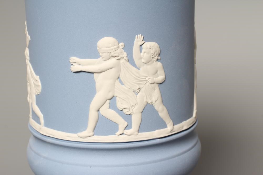 A WEDGWOOD BLUE JASPERWARE PEDESTAL VASE AND COVER, modern, of cylindrical form, moulded and applied Image