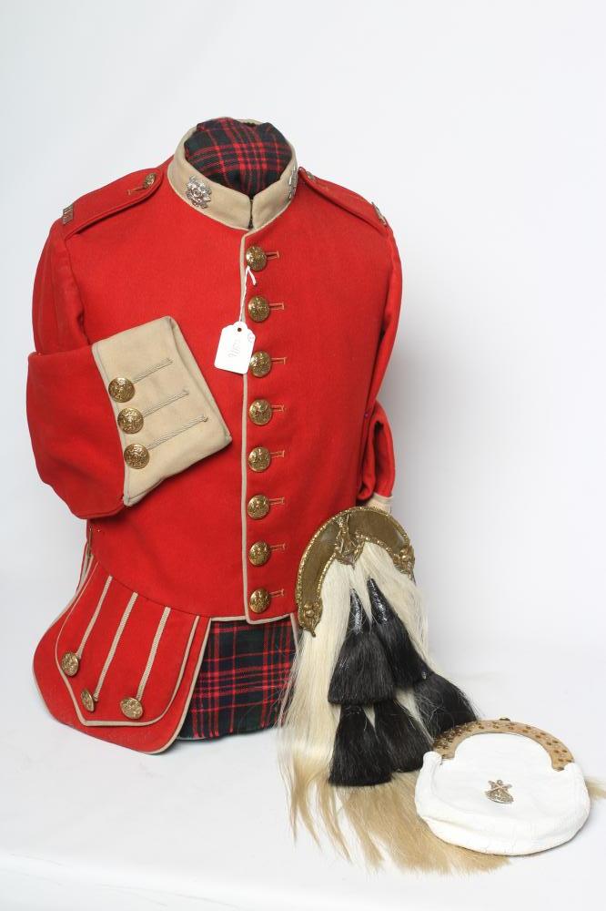 A HIGHLAND LIGHT INFANTRY RED TUNIC, together with a Royal Highland regimetal sporran, and a "Peter Image