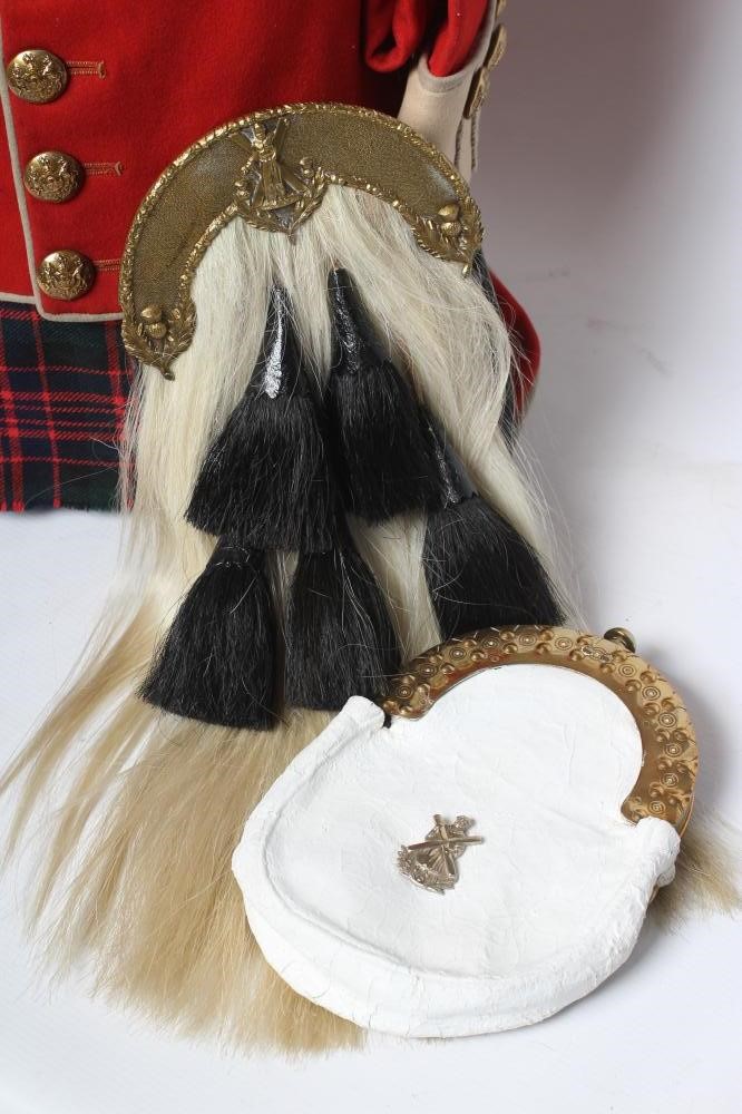 A HIGHLAND LIGHT INFANTRY RED TUNIC, together with a Royal Highland regimetal sporran, and a "Peter Image