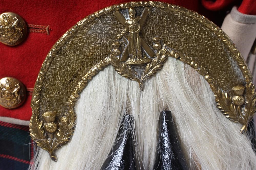 A HIGHLAND LIGHT INFANTRY RED TUNIC, together with a Royal Highland regimetal sporran, and a "Peter Image