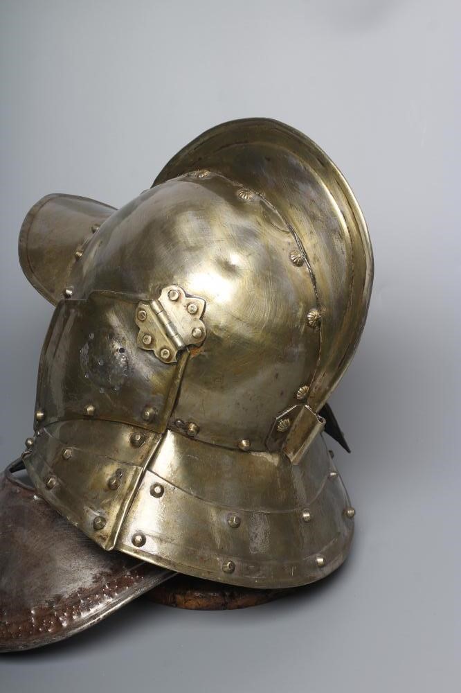 A REPRODUCTION BURGONET HELMET with high medial ridge, rounded peak, neck and ear guards, together Image