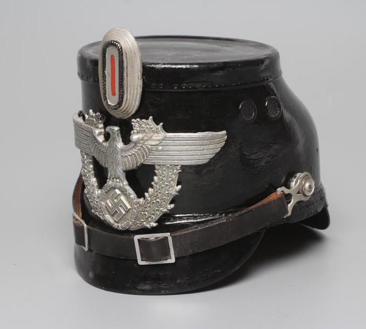 A SECOND WORLD WAR GERMAN POLICE SHAKO, with large metal Third Reich eagle badge, peak, leather chin Image