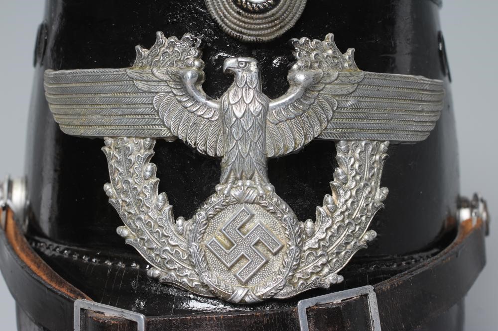 A SECOND WORLD WAR GERMAN POLICE SHAKO, with large metal Third Reich eagle badge, peak, leather chin Image