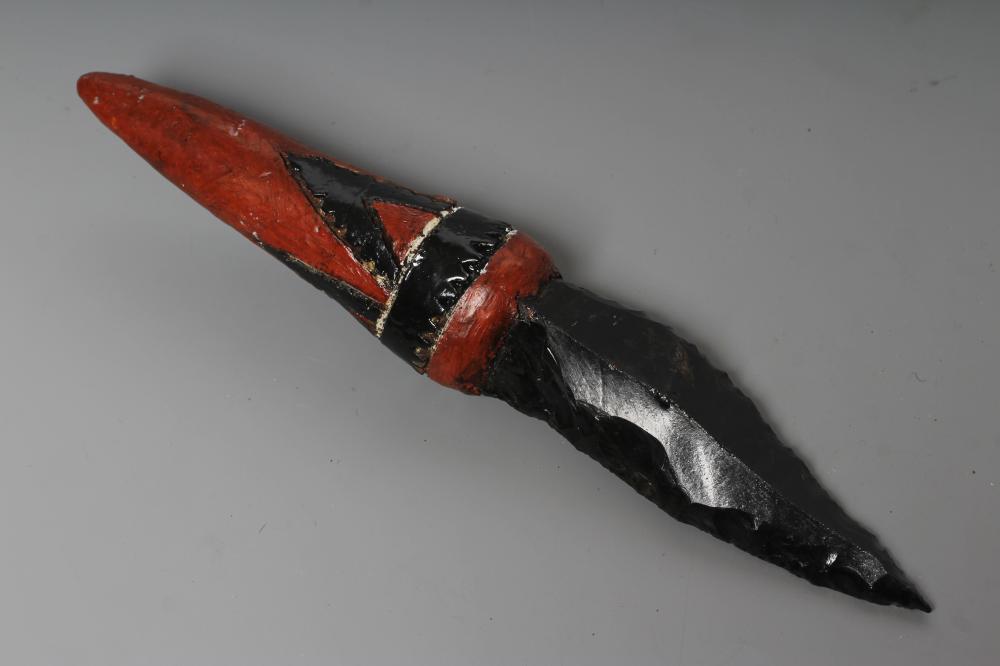 AN OBSIDIAN DAGGER, from Papua New Guinea, with 4 5/8" blade and painted tapering grip, 9 3/4" long Image