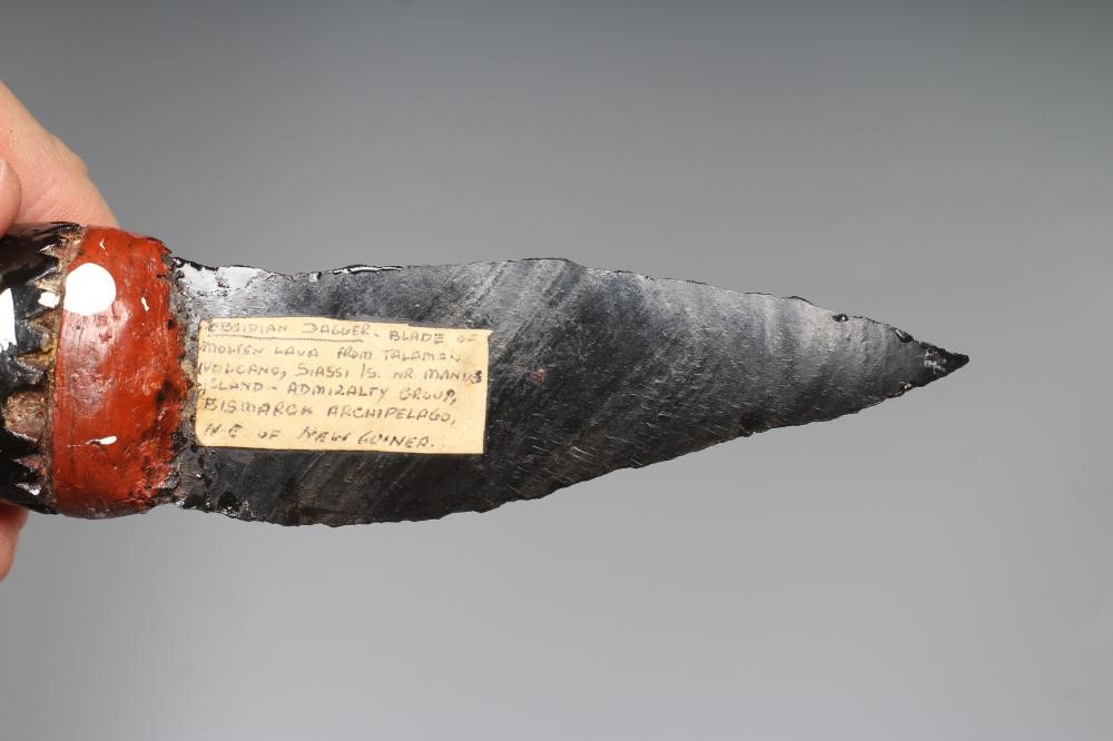 AN OBSIDIAN DAGGER, from Papua New Guinea, with 4 5/8" blade and painted tapering grip, 9 3/4" long Image